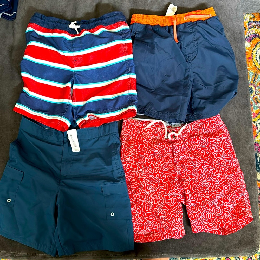 4 swim shirts and 4 swim trunks lot, 8 items total. All youth S/M size 6 and 7.